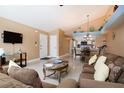 Spacious living room with vaulted ceilings, comfortable seating, and views to the kitchen and dining area at 5012 Laguna Bay Cir # 74, Kissimmee, FL 34746