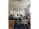 Living room with gray couch, coffee table, and decorative wall art at 8713 Sw Rockingham Ter # D, Kissimmee, FL 34747