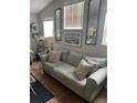 Living room featuring a gray couch, decorative pillows, and wall art at 8713 Sw Rockingham Ter # D, Kissimmee, FL 34747