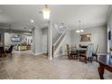 Open dining room with tile floors and a view of the living room at 7714 Excitement Dr, Reunion, FL 34747