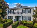 Two story home with balcony and manicured landscaping at 7714 Excitement Dr, Reunion, FL 34747