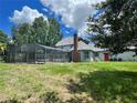 House backyard with screened pool and spacious grassy area at 2086 Camelot Blvd, St Cloud, FL 34772