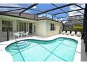 Relaxing screened-in pool area with patio furniture and a spacious pool at 648 Copeland Dr, Haines City, FL 33844