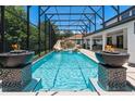 Resort-style pool with fire bowls and a waterfall feature at 5222 Waterside Vista Ln, St Cloud, FL 34771