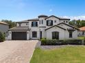 Two story house with a three car garage and manicured lawn at 5222 Waterside Vista Ln, St Cloud, FL 34771