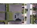 Aerial view of a house with solar panels and a backyard at 2414 Fenetre Ln, Kissimmee, FL 34741