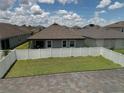 Large backyard with a white fence and grassy area at 2414 Fenetre Ln, Kissimmee, FL 34741