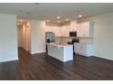 Modern kitchen with white cabinets, stainless steel appliances, and an island at 4422 Small Creek Rd # 72, Kissimmee, FL 34744