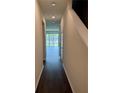 Bright entryway with dark hardwood floors and view of the backyard at 4422 Small Creek Rd # 72, Kissimmee, FL 34744
