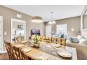 Dining room with table, chairs, and view into living room at 3227 Cupid Pl, Kissimmee, FL 34747