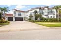 Two-story home with three car garage and manicured lawn at 7459 Gathering Dr, Reunion, FL 34747