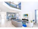 Open living space with high ceilings, a dining area, and modern furniture at 3028 Protagonist St, Kissimmee, FL 34746