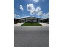 Single-wide manufactured home with carport and landscaped yard at 5013 Foxwood Blvd, Lakeland, FL 33810