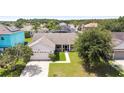 Bird's-eye view of a house with a green lawn and neighborhood at 2419 Willow Tree Ln, Kissimmee, FL 34758