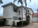 Two-story Mediterranean style home with lush landscaping at 730 Brunello Dr, Davenport, FL 33897