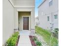 Inviting exterior featuring a charming walkway and well-manicured landscaping at 3920 Saltmarsh Loop, Sanford, FL 32773