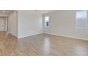 Bright living room with wood-look tile flooring and neutral walls at 4256 Sawtooth Ct, Tavares, FL 32778