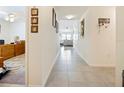 Bright hallway leading to the main living areas, with access to a home office at 2894 Mosshire Cir, Saint Cloud, FL 34772