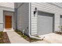 Townhouse exterior showcasing the gray siding and orange door at 4801 Sparkling Shell Ave, Kissimmee, FL 34746