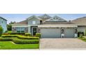 Two-car garage and welcoming front porch enhance this beautiful home's exterior at 12151 Alder Branch Loop, Orlando, FL 32824
