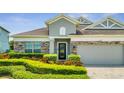 Curb appeal abounds in this charming one-story home featuring stone accents and lush landscaping at 12151 Alder Branch Loop, Orlando, FL 32824
