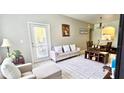 Living room features a sofa, chairs, and dining table at 6335 Contessa Dr # 205, Orlando, FL 32829