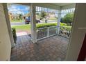 Covered front porch with brick pavers and white railings at 2143 Victoria Dr, Davenport, FL 33837