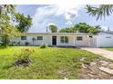 Charming single story home with white exterior and black door at 1842 Puritan Ave, Winter Park, FL 32792