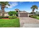 House exterior with palm trees and a brick driveway at 500 Playa Dr, Davenport, FL 33837