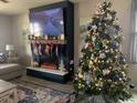 Cozy living room with a fireplace, decorated for the holidays at 2867 Matera Dr, St Cloud, FL 34771