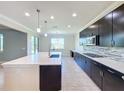 Modern kitchen with island, stainless steel appliances, and ample counter space at 3510 Mediterra Dr, Clermont, FL 34711