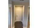 Well-lit hallway with tile floors and neutral colors at 11460 Chateaubriand Ave, Orlando, FL 32836