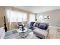 Spacious living room with comfortable seating and large windows at 5144 Adelaide Dr, Kissimmee, FL 34746