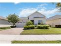 House exterior features a two-car garage and landscaped yard at 5006 Sunfalls Ave, Saint Cloud, FL 34772