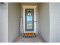 Inviting entryway with a gray door, welcome mat, and 'Home Sweet Home' decor at 2867 Matera Dr, Saint Cloud, FL 34771