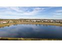 Community lake view with homes and landscape at 3171 Paradox Cir # 403, Kissimmee, FL 34746