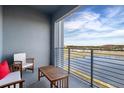Relaxing balcony with lake views and outdoor furniture at 3171 Paradox Cir # 403, Kissimmee, FL 34746