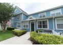 Light blue townhome with white picket fence and landscaping at 4004 San Gallo Dr # 104, Kissimmee, FL 34741