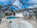 Relaxing pool area with screened enclosure and lounge chairs at 7978 Magnolia Bend Ct, Kissimmee, FL 34747