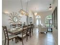 Spacious dining room with a large table and view to the living room at 7978 Magnolia Bend Ct, Kissimmee, FL 34747