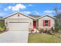 New construction home with red door and stone accents at 2043 Stetson Ct, Eagle Lake, FL 33839