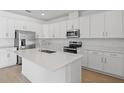 Modern kitchen with white cabinets and island at 2043 Stetson Ct, Eagle Lake, FL 33839