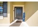 Front door entry with welcome mat and decor at 2662 Trafalgar Blvd, Kissimmee, FL 34758