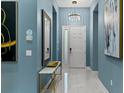 Bright entryway with a large mirror and modern light fixture at 1735 Oak Blossom Dr, Davenport, FL 33837