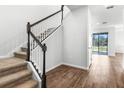 Modern staircase with dark wood railings and carpeted steps at 821 Blue Creek Dr, Haines City, FL 33844