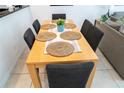 Dining area with light wood table and six dark gray chairs at 3006 Red Ginger Rd, Kissimmee, FL 34747