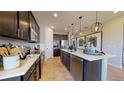 Modern kitchen with dark cabinetry and quartz countertops at 628 Hennepin Loop, Lake Wales, FL 33898