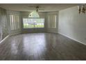 Spacious living room with wood-look tile and large window at 2022 Royal Bay Blvd # 93, Kissimmee, FL 34746