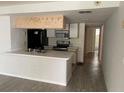 Kitchen with breakfast bar, stainless steel appliances, and tile floor at 2022 Royal Bay Blvd # 93, Kissimmee, FL 34746