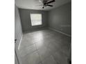 Spacious bedroom with tile floors and large window at 9817 Turf Way # 8, Orlando, FL 32837